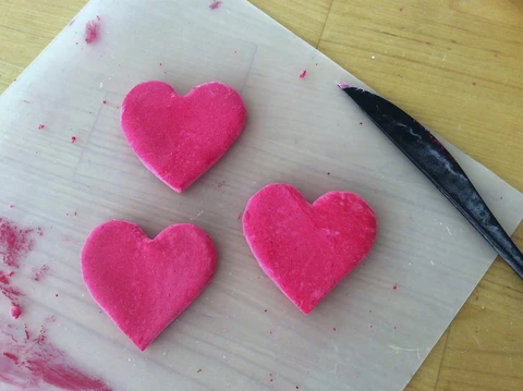 Making air dry clay Sacred Heart magnets is fun.